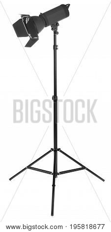 Modern powerful photographic flash. Studio lighting, isolated on the white background. Professional black equipment. Studio photography video light. A long tripod.