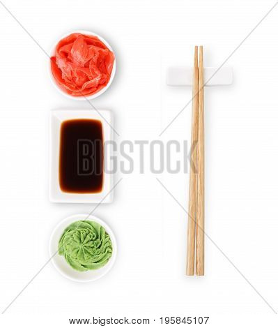 Set of sushi tablewear. Top view on saucer with soy sauce, small white bowls for ginger and wasabi and chopsticks at white background. Flat lay, copy space