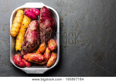 Peruvian raw ingredients for cooking - yuca, colored sweet potatoes and camote batata. Top view.