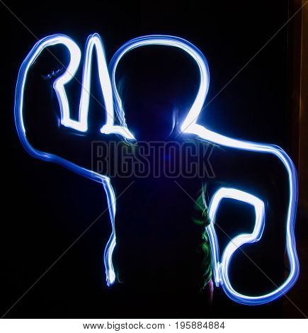 Freezelight silhouette of a man on a dark background. comic photo.