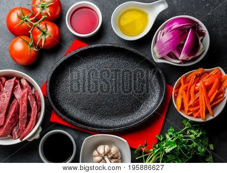 Ingredientes For Cooking Peruvian Dish Lomo Saltado - Tenderloin Beef, Vegetables Around Black Plate