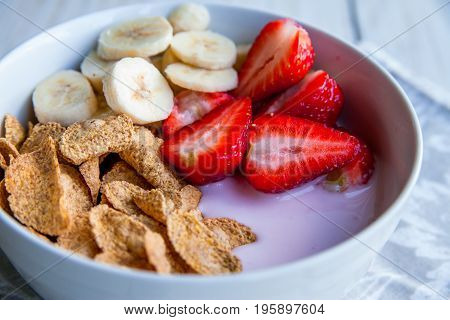 Healthy Breakfast which included cornflakes and oatflakes, yogurt, bananas and strawberries