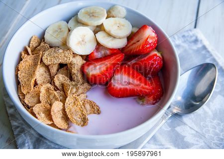 Healthy Breakfast which included cornflakes and oatflakes, yogurt, bananas and strawberries