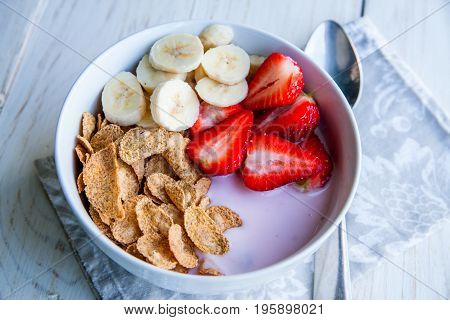 Healthy Breakfast which included cornflakes and oatflakes, yogurt, bananas and strawberries