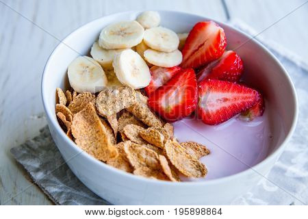 Healthy Breakfast which included cornflakes and oatflakes, yogurt, bananas and strawberries