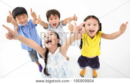 Group of happy smiling kids with thumb up