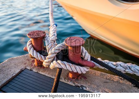 Mooring Bollard with rope on pier by the sea.