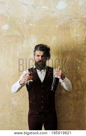 Hipster Holding Bottle And Glass Of Wine