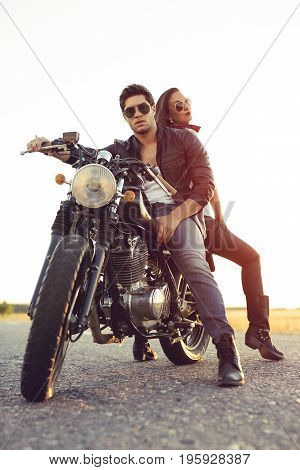 Sexy couple of bikers on the vintage custom motorcycle