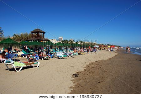 MARBELLA, SPAIN - SEPTEMBER 12, 2008 - Tourists relaxing on Playa de la Vibora beach Elviria Marbella Malaga Province Andalusia Spain Western Europe, September 12, 2008.