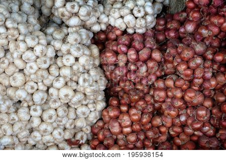 garlic and red onion for sell at local farmer's market in Thailand. ingredient cooking background