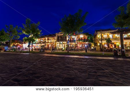 Hoi An, Vietnam - August 14, 2015: restaurants and shops on the banks of the Thu Bon river on Nguyen Phuc Chu in Hoi An at night.