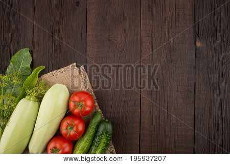 Ripe vegetables on an old wooden table. Top view.