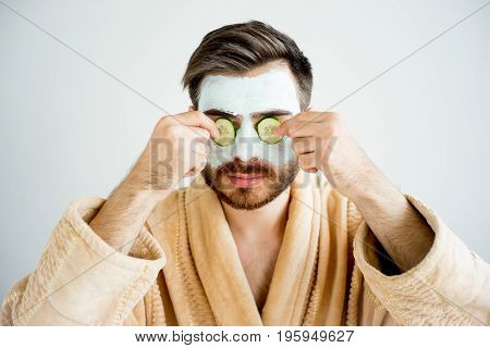 A portrait of a man with a mud mask