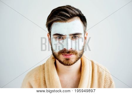 A portrait of a man with a clay mask