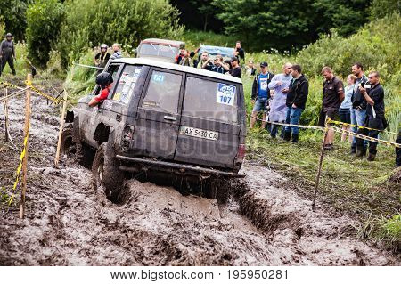 LUBOTIN UKRAINE - JULY 23 2016: RFC Ukraine Wild Boar Challenge 2016. Toyota LandCruiser Prado 70 driving through deep mud.