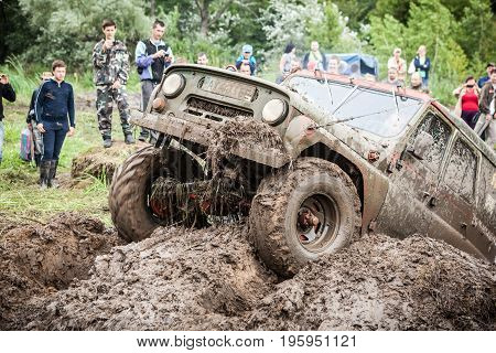 LUBOTIN UKRAINE - JULY 23 2016: RFC Ukraine Wild Boar Challenge 2016. Custom built Off-road Trophy UAZ 469 passing mud pit.