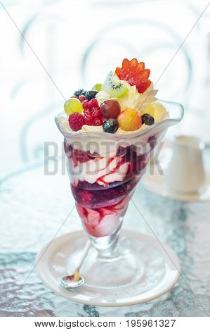 Delicate berry cream dessert in a kremanka on a table in a cafe