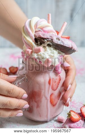 Pink strawberry freakshake milkshake with sweets donut and marshmallow