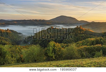 Autumn nature with misty landscape, Holbav village, Carpathians, Transylvania Romania Europe