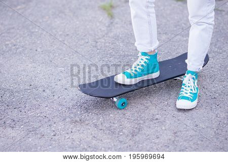 Beautiful girl rides on a highway on Longboard scenic street. Solar toning. Close-up portrait. Healthy lifestyle.