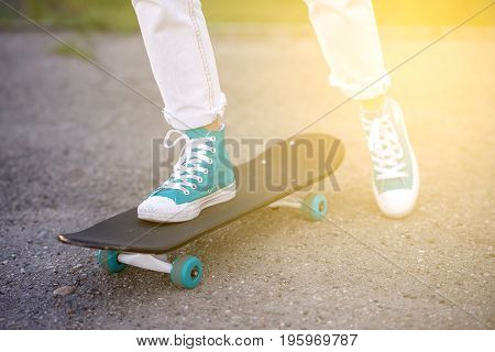 Beautiful girl rides on a highway on Longboard scenic street. Solar toning. Close-up portrait. Healthy lifestyle.