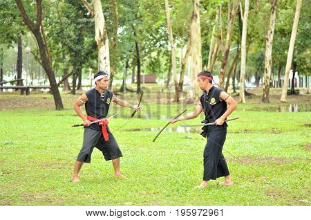 PUKED,THAILAND - AUGUST 28: Master trick of ancient fighter on August 28, 2011 in Puked Thailand.
 Master show how to trick of fight with swords.