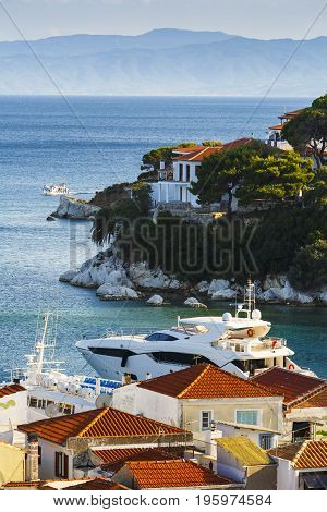 View of the old harbour on Skiathos island and Euboea in the distance, Greece.