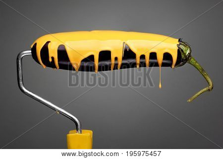Paint Roller Eggplant With Pouring Yellow Paint On Gray Background. Fashion Food Concept.creative Ad