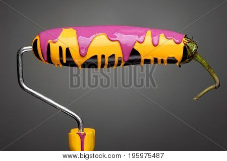 Paint Roller Eggplant With Pouring Yellow And Purple Paint On Gray Background. Fashion Food Concept.
