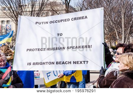 Washington DC USA - March 6 2014: People holding sign of Vladimir Putin and Russia during Ukrainian protest by White House