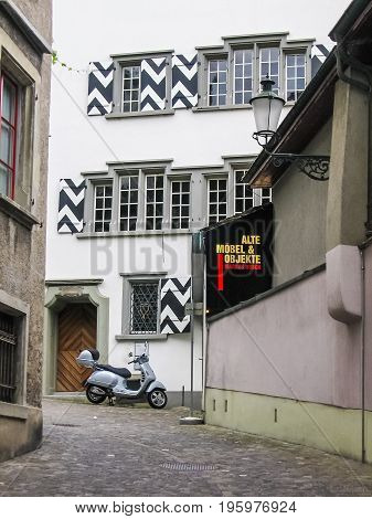 Zurich, Switzerland - August 9, 2007: Downtown City With Motorcycle And Sign Of Alte Mobel And Objek