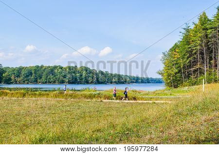 Burke USA - October 6 2013: People walking their dogs on trail in Burke Lake Park in Virginia