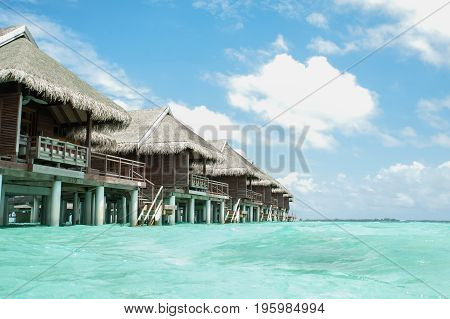 Water villas  in the Maldives.  Blue sky and turquoise water