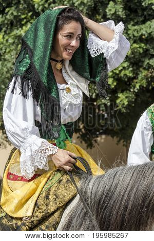 SELARGIUS, ITALY - SEPTEMBER 13, 2015: Ancient married celibacy - portrait of a beautiful woman dressed in Sardinian costume with her horse - Sardinia
