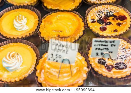 Small Lemon Meringue Tarts With Whipped Egg Whites On Display In Bakery With Signs In French