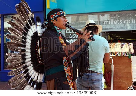 Reading, Uk - June 17Th 2017: Native South American Flute Player In Traditional Costume With Feather