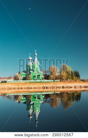 Old Wooden Russian Orthodox Church Near Lake In Early Spring Or Late Autumn Season. Sunny Day.