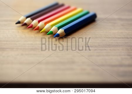 Tips of fat and short Colored pencils on a wooden desk.Shallow depth of field for dreamy feel.