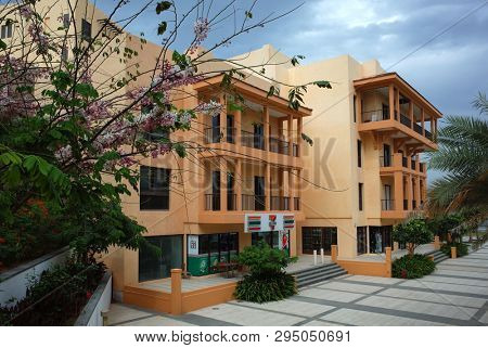 Dibba Al-Fujairah, Fujairah, UAE - April 8, 2019: Apartment buildings with 7 eleven convenience store
