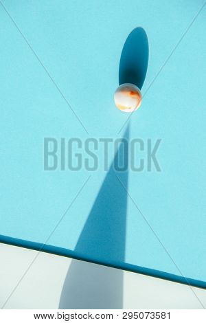 Artistic background with a glass marble with intrasting shadows. 