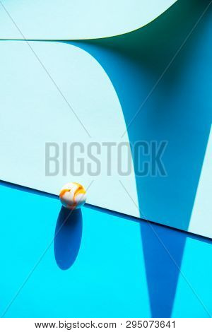 Artistic background with a glass marble with intrasting shadows. 
