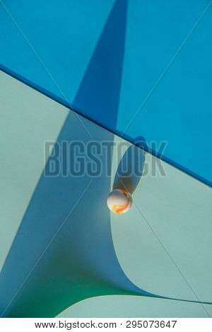 Artistic background with a glass marble with intrasting shadows. 