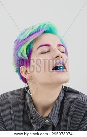 A Young Woman With Short Hair, A Pixie Bob Haircut, Different Colored Hair, Blue, Green, Violet. Hol