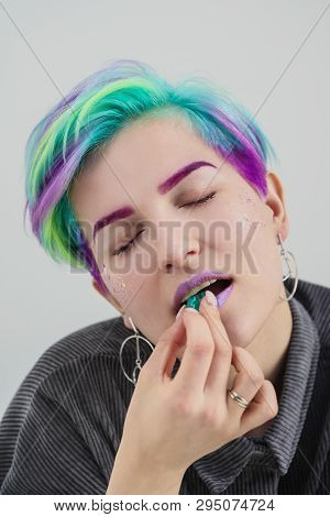 A Young Woman With Short Hair, A Pixie Bob Haircut, Different Colored Hair, Blue, Green, Violet. Hol