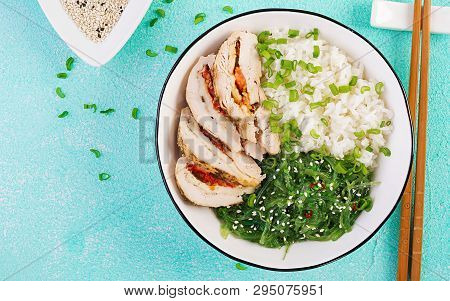 Healthy Salad In A White Bowl, Chopsticks. Chicken Rolls, Rice, Chuka And Green Onion. Blue Backgrou