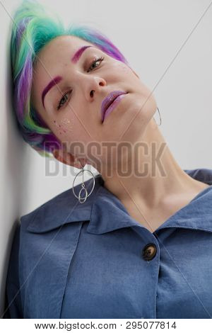 A Young Woman With Short Hair, A Pixie Bob Haircut, Different Colored Hair, Blue, Green, Violet.