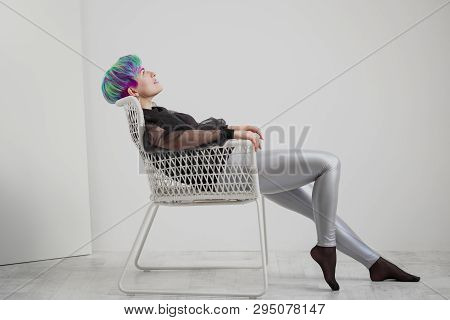 A Young Woman With Short Hair, A Pixie Bob Haircut, Different Colored Hair, Blue, Green, Violet.