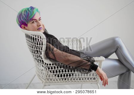 A Young Woman With Short Hair, A Pixie Bob Haircut, Different Colored Hair, Blue, Green, Violet.