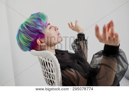 A Young Woman With Short Hair, A Pixie Bob Haircut, Different Colored Hair, Blue, Green, Violet.